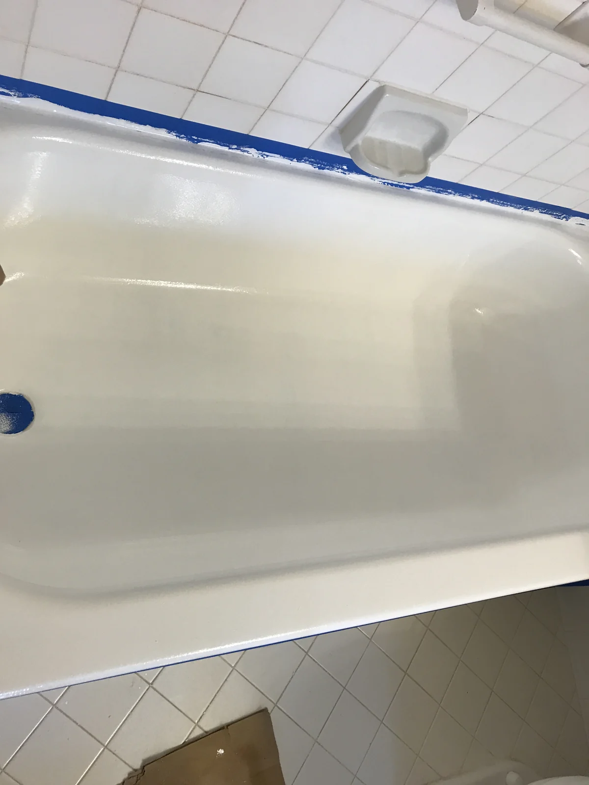Bathtub surface with blue masking tape along the edges