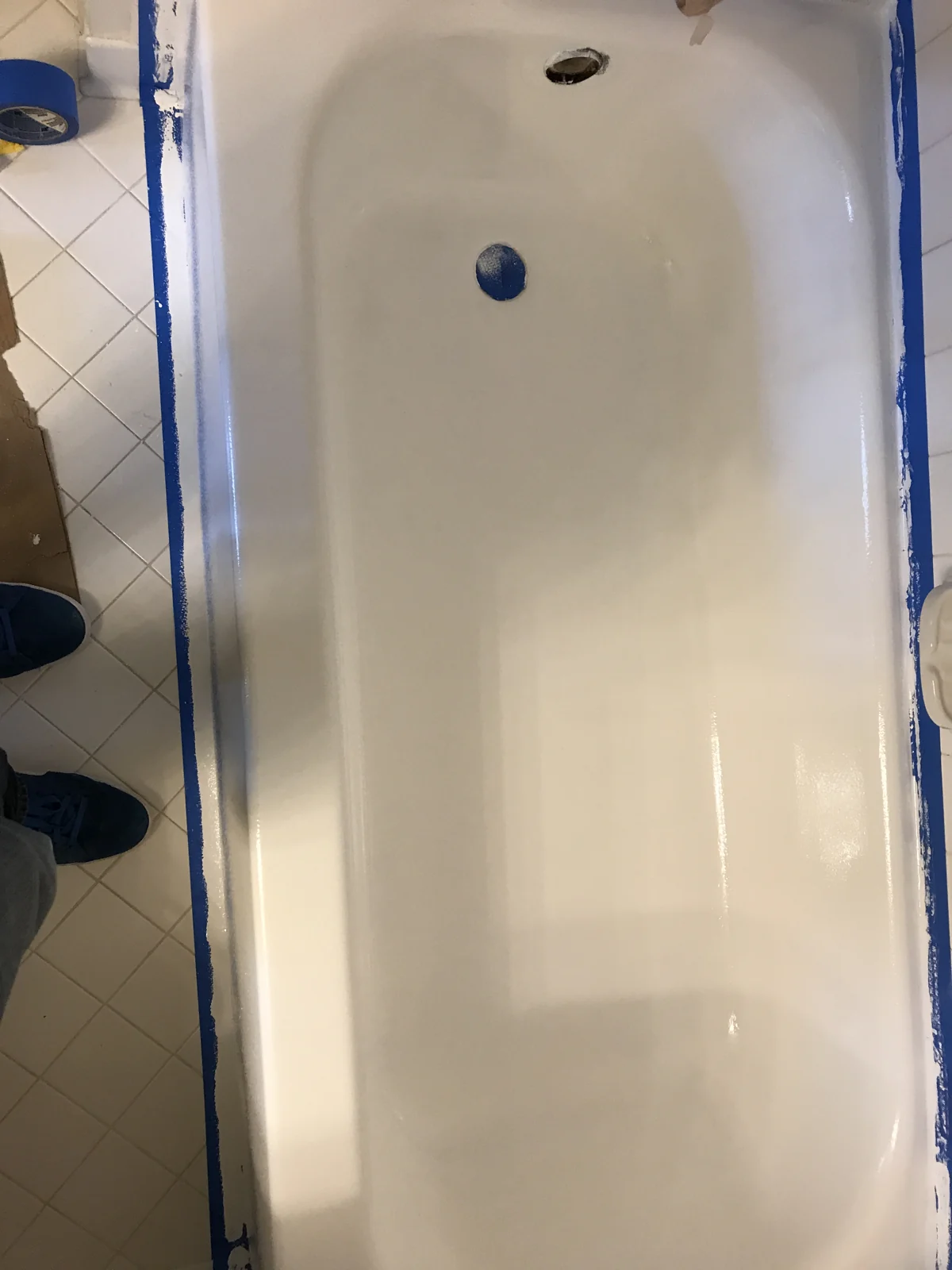 Bathtub surface and drain openings with masking tape