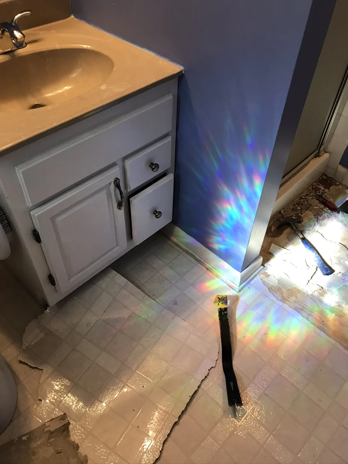 Bathroom floor removal beside a vanity