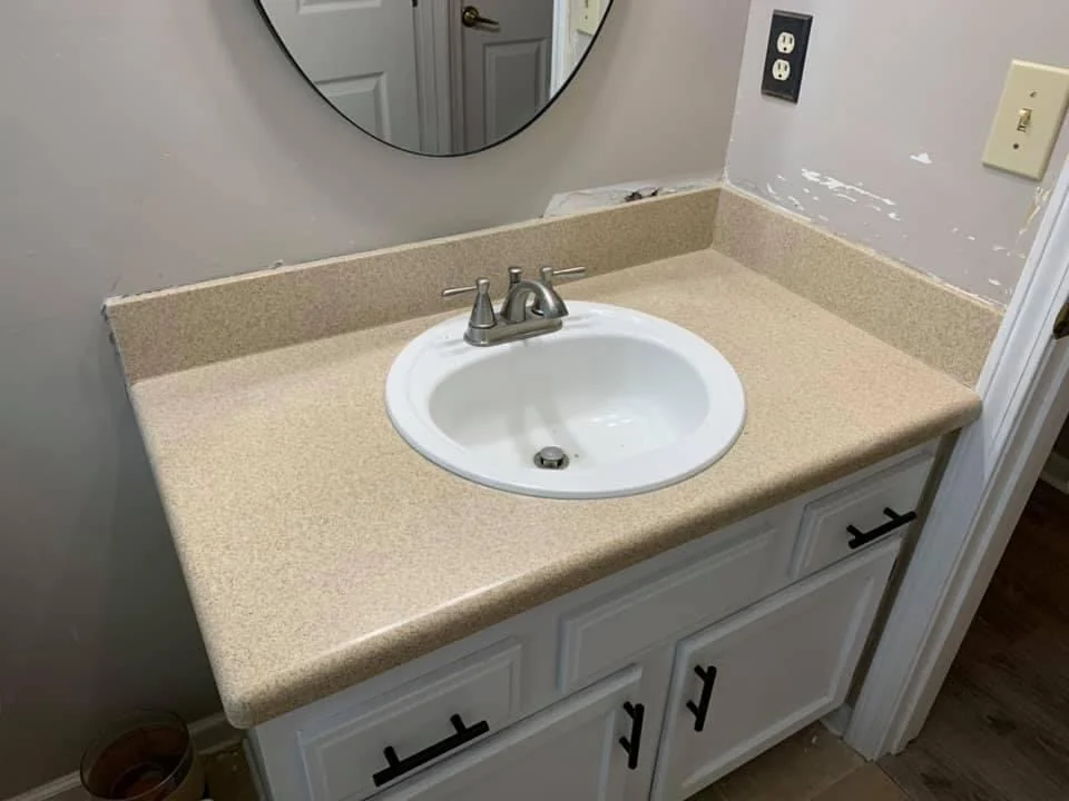 Bathroom vanity with a tan countertop
