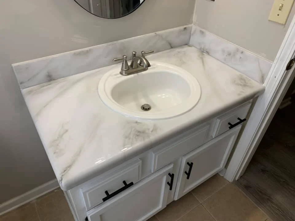 Bathroom vanity with a light marble-patterned countertop