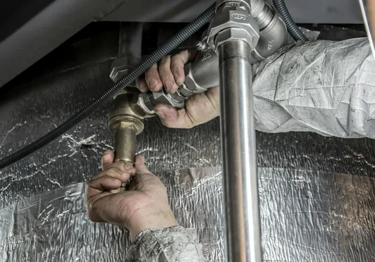 Plumbing components beneath a sink